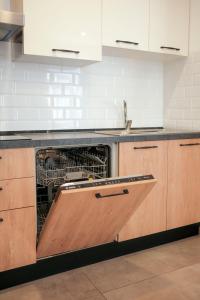a dishwasher with its door open in a kitchen at Tan-Nanna by Shmoo, Sliema Ferries in Sliema +35 photos