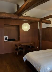 a bedroom with a bed and a table and a tv at BLANKS - Vacation STAY 37519v in Taisha