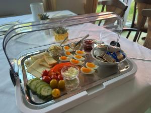 a glass display of food on a table at Pension Störtebeker in Prerow