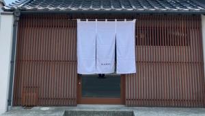 a building with white towels hanging on a door at BLANKS - Vacation STAY 37519v in Taisha