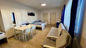 a small room with a bed and a table at Pension Fontána Svitavy in Svitavy