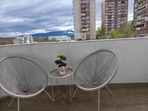 two chairs and a table on a balcony at Kasibel Suites in Sandanski