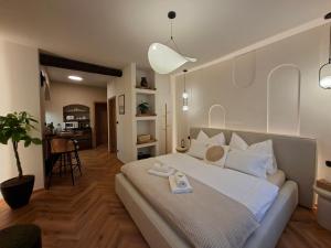 a bedroom with a large bed with a scale on it at Old Town Living Studio in Český Krumlov