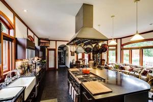 a large kitchen with a stove and a couch at East Hampton Art House Bed and Breakfast in East Hampton