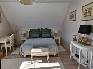a bedroom with a bed and a table and a chair at Ancenis Suite Rooms in Ancenis