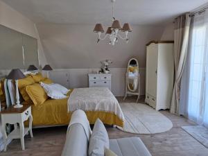 a bedroom with a bed and a dresser and a mirror at Ancenis Suite Rooms in Ancenis