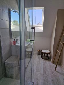 a bathroom with a shower and a sink and a window at Ancenis Suite Rooms in Ancenis +3 photos