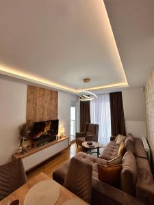 a living room with a couch and a tv at Green Peak in Divčibare