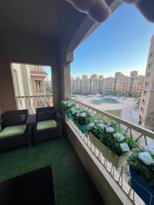 a balcony with chairs and a view of a beach at AQUA View resort in El Alamein