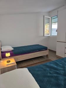 a bedroom with a bed and a window at Olive Grove Retreat Podgorica in Vranj