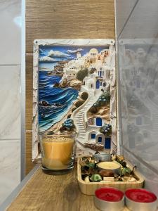 a box with a painting of a beach and a drink at Green Peak in Divčibare