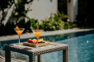 a table with two martini glasses and fruit on it at Villa Cecilia in Göcek