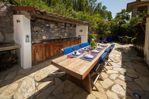 a wooden table and chairs on a patio at Villa Cecilia in Göcek