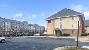 a building with a parking lot with cars parked at Studio 6 Chantilly VA Washington Dulles Airport in Chantilly