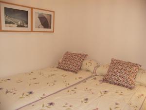 a bed with two pillows on it in a room at Apartamentos Plaza España in Nerja