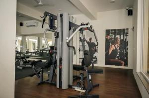 a gym with several tread machines in a room at Casa Lobo in Mapusa