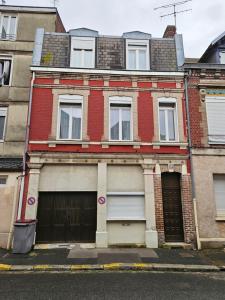 a red brick house with a garage at LD Atmosphère in Saint-Quentin