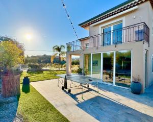 a ping pong table in front of a house at Villa SYAGRUS - Easy Home Booking in Nice