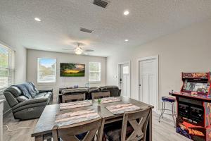 a living room with a table and some chairs at 1mi to Downtown! 3BR6BedsScreenroom,Deck,Firepit in St. Augustine