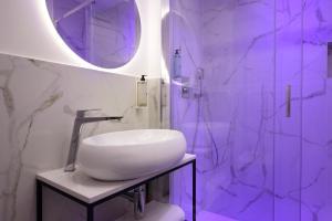 a bathroom with a white sink and a mirror at Hotel Patria in Rome +59 photos