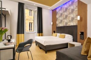 a hotel room with a bed and a chair at Hotel Patria in Rome