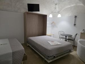 a bedroom with a bed and a sink and a tub at La suite del Marchese a Vieste in Vieste