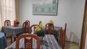 a dining room with a table and chairs with flowers at Hotel Molí Beach in Benidorm