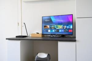 a computer monitor sitting on a desk with a mouse at Le Parvis - Studio cosy hyper centre - Proche gare in Tours