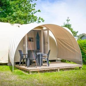 a tent with two chairs and a table in it at Friendly Camping and Lodges in Saint-Pardoux-la-Rivière