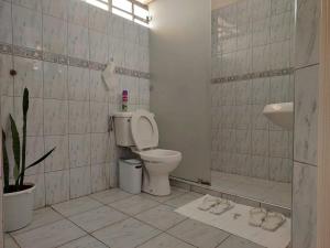 a bathroom with a toilet and a sink at Dobajo Homes2 in Kisumu +12 photos