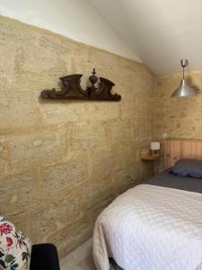 a bedroom with a bed and a shelf on the wall at l'atelier by Emma in Bommes