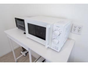 a microwave oven sitting on top of a table at Turtle Two Three - Vacation STAY 87759v in Miyako-jima