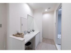 a white bathroom with a sink and a mirror at Turtle Two Three - Vacation STAY 87759v in Miyako-jima +12 photos