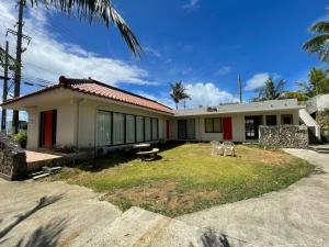 a house with two chairs in front of it at Turtle Two Three - Vacation STAY 87759v in Miyako-jima