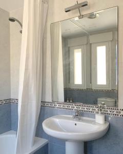 a bathroom with a sink and a mirror at Ático dúplex - 1ª Linea playa in Adra +44 photos