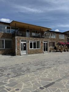 a brick building with a balcony on top of it at Vibe Hotel Vanadzor in Vanadzor