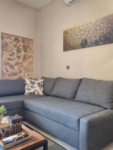 a blue couch in a living room with a table at Sogno 2 in Parga