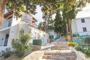 a house with a sign on the side of it at Lumbarda Resort Apartments in Lumbarda +130 photos