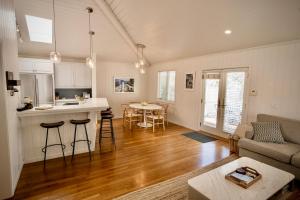 a kitchen and living room with a couch and a table at Beachbound Bliss in Del Mar in San Diego