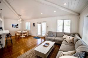 a living room with a couch and a table at Beachbound Bliss in Del Mar in San Diego