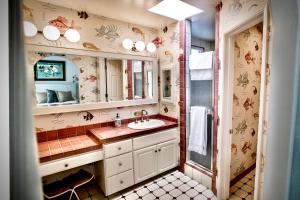 a bathroom with a sink and a mirror at Beachbound Bliss in Del Mar in San Diego +16 photos