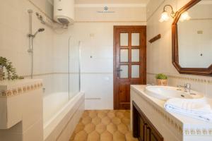 a bathroom with a sink and a tub and a shower at Domo de Iannas-House Live Express in Quartu Sant'Elena +187 photos