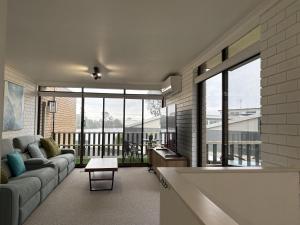 a living room with a couch and a large window at Water Views Nagambie in Nagambie +7 photos