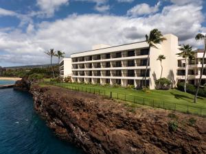 a hotel on a cliff next to the water at Sheraton Maui Resort & Spa in Lahaina