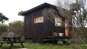 a tiny house with a picnic table in front of it at Las Chircas Chapadmalal in Chapadmalal