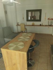 a wooden table in a room with chairs and a mirror at The Spot 1 in Larisa