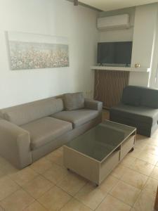 a living room with a couch and a coffee table at The Spot 1 in Larisa