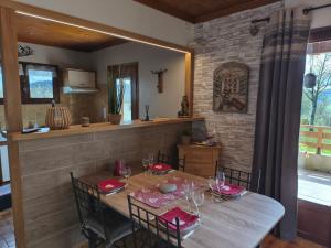 a dining room with a wooden table and chairs at Le chalet de Maryvonne in Gibles