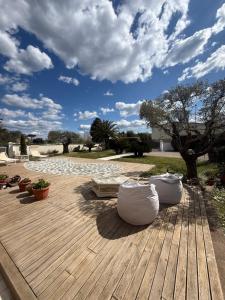 a patio with three white bean bags on a wooden deck at Villa Concetta in Torre del Lago Puccini