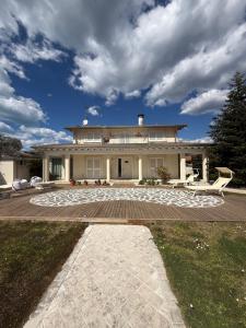 a large house with a patio in front of it at Villa Concetta in Torre del Lago Puccini